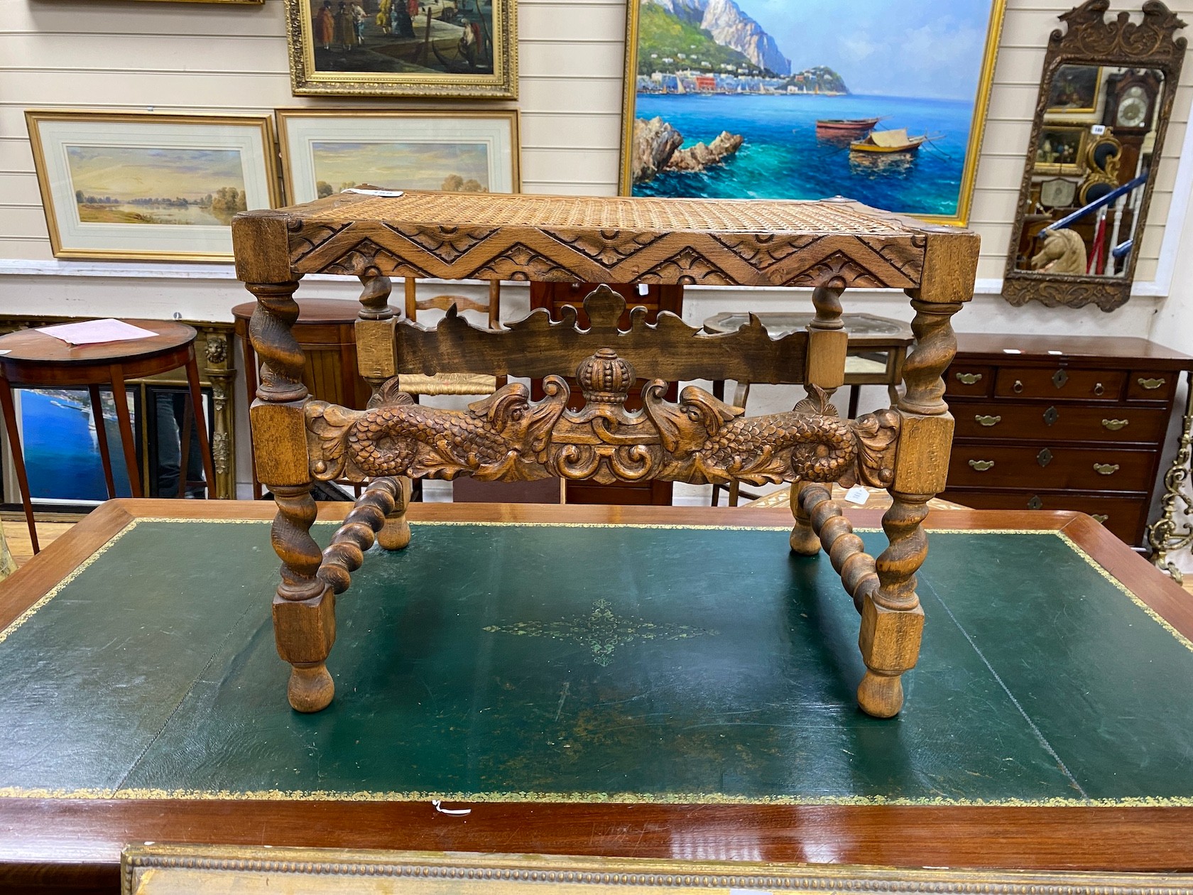 A Jacobean revival caned carved beech stool width 59cm, height 46cm.